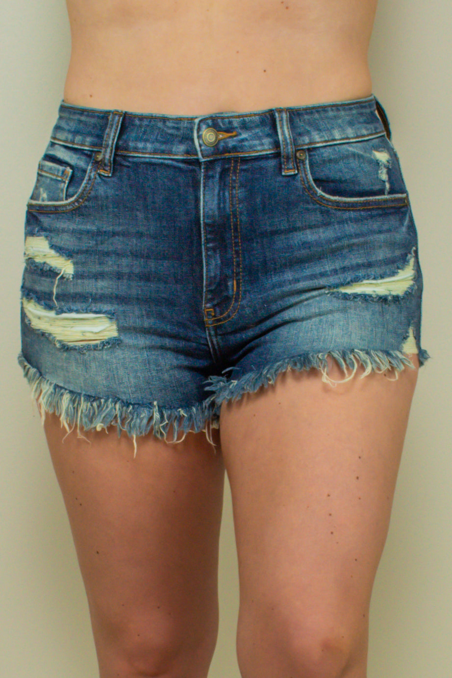 high waisted dark wash distressed denim shorts with frayed ends, front view